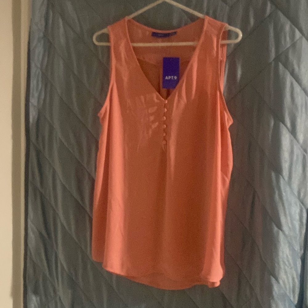 Never worn! Light pink, sleeveless tank with buttons size large.